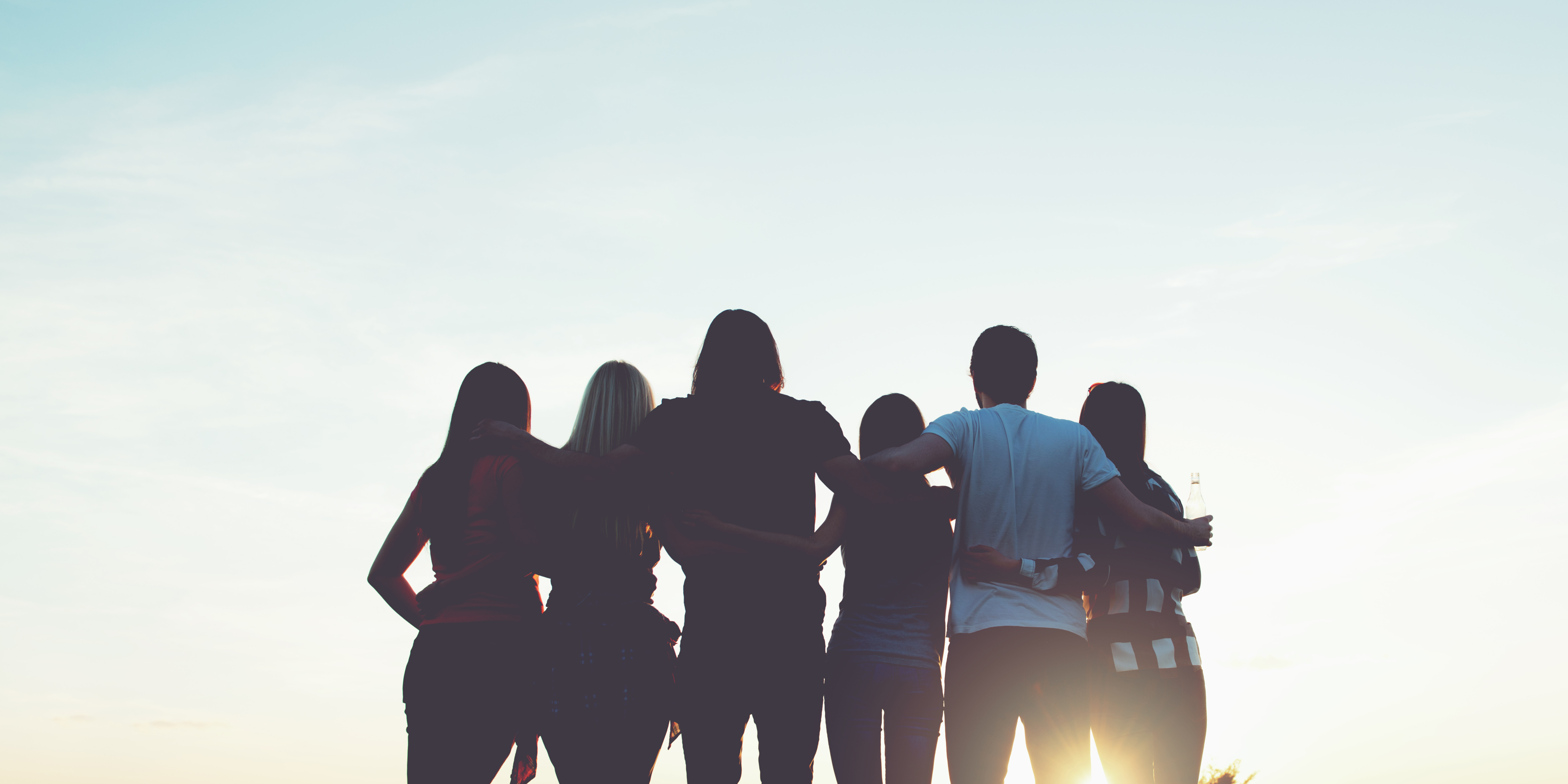 three men and laughing two women walking side by side
